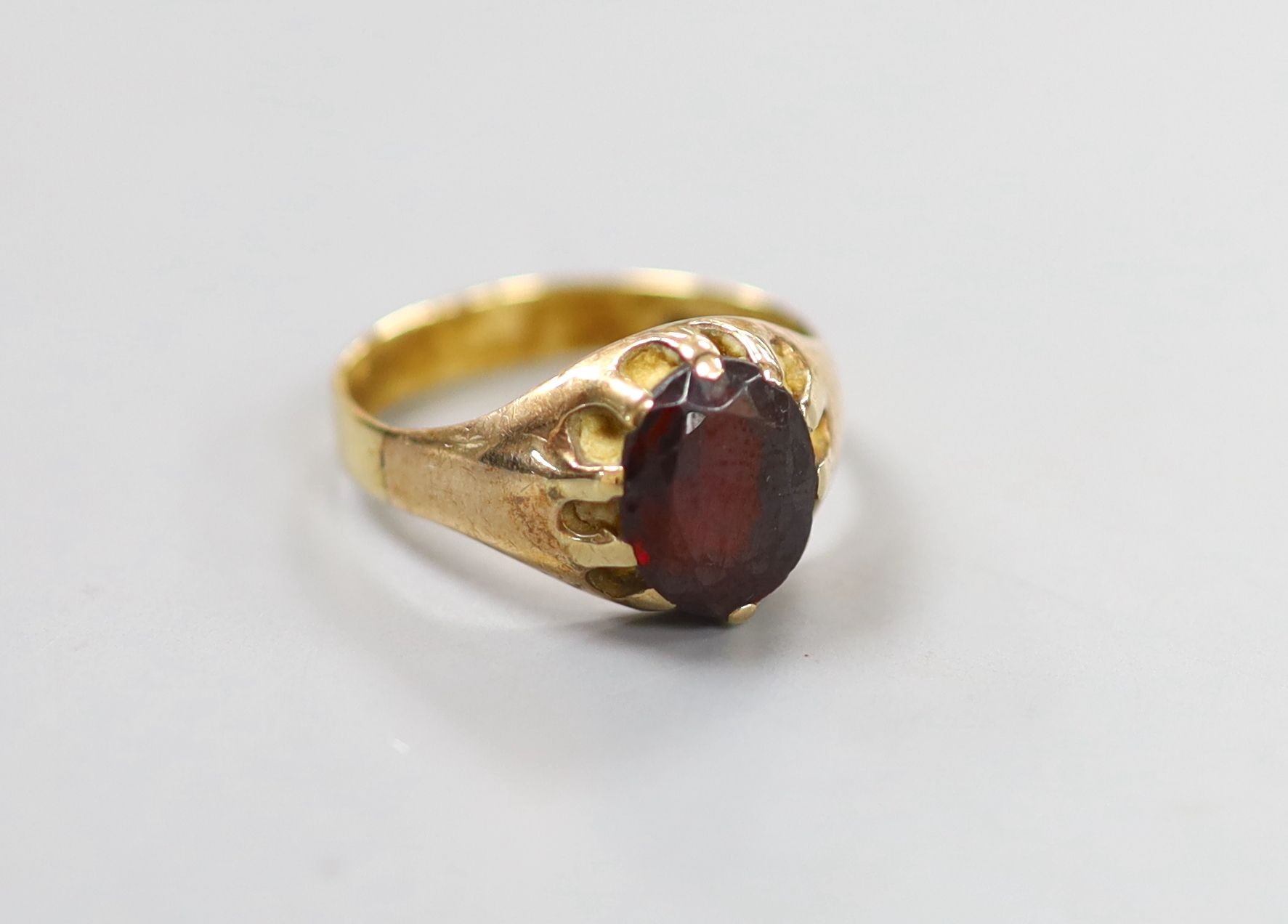 A 9ct gold and claw set oval cut garnet ring, size Q, gross 3.6 grams (stone worn).